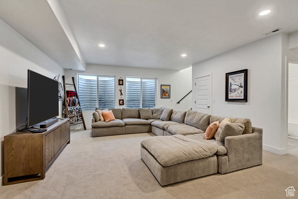 Living area featuring light carpet and recessed lighting