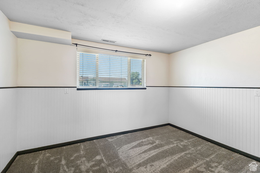 Spare room with carpet floors and wainscoting