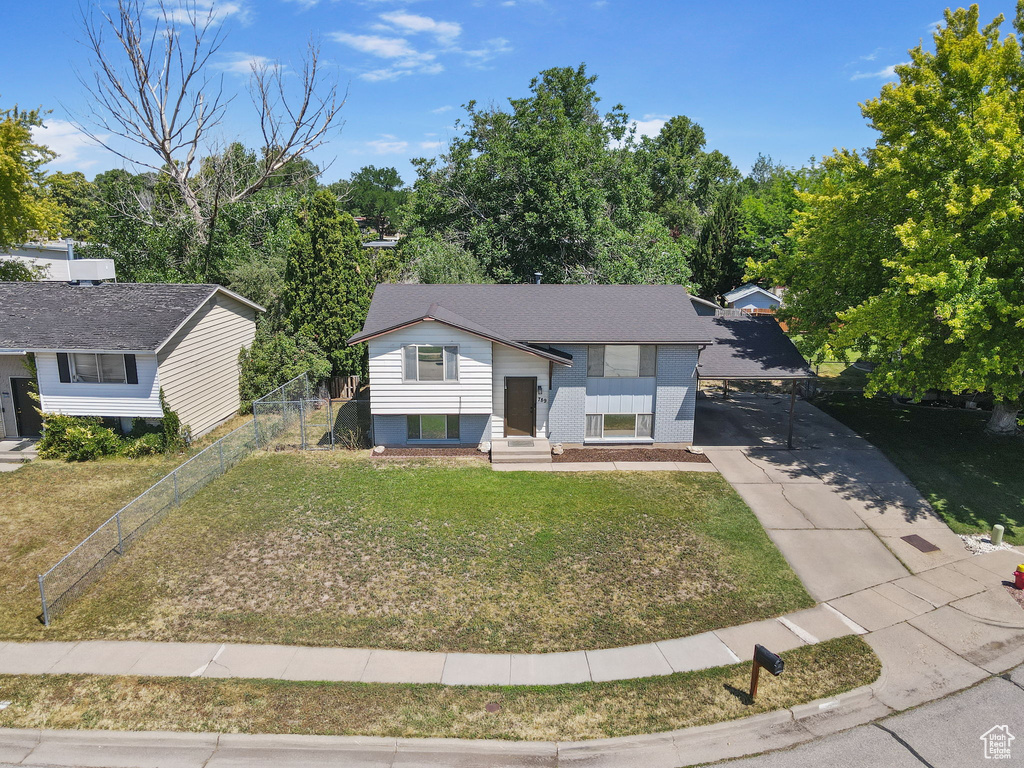 Bi-level home with driveway and a carport