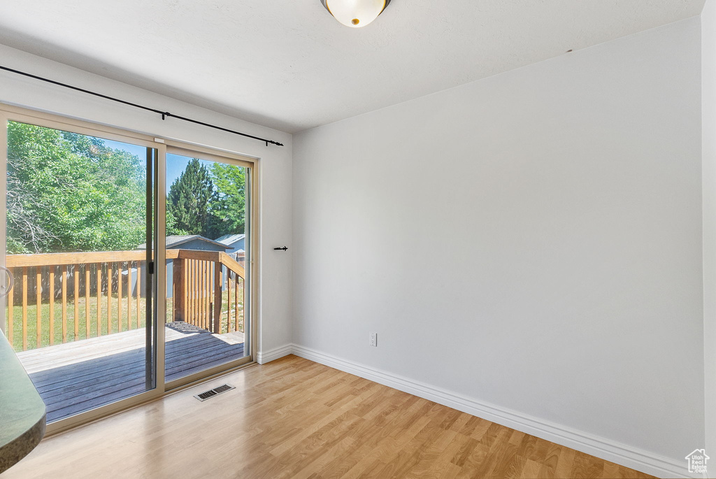 Spare room with light wood-type flooring and baseboards