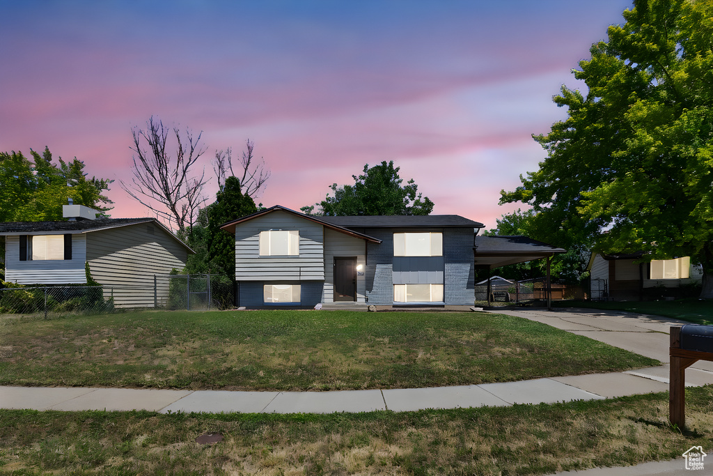 View of front of home featuring an attached carport and concrete driveway