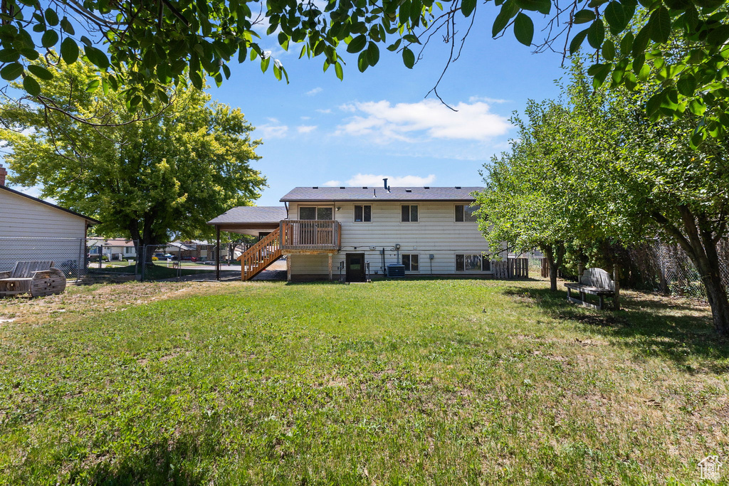 Back of house with stairs, a fenced backyard, and a wooden deck