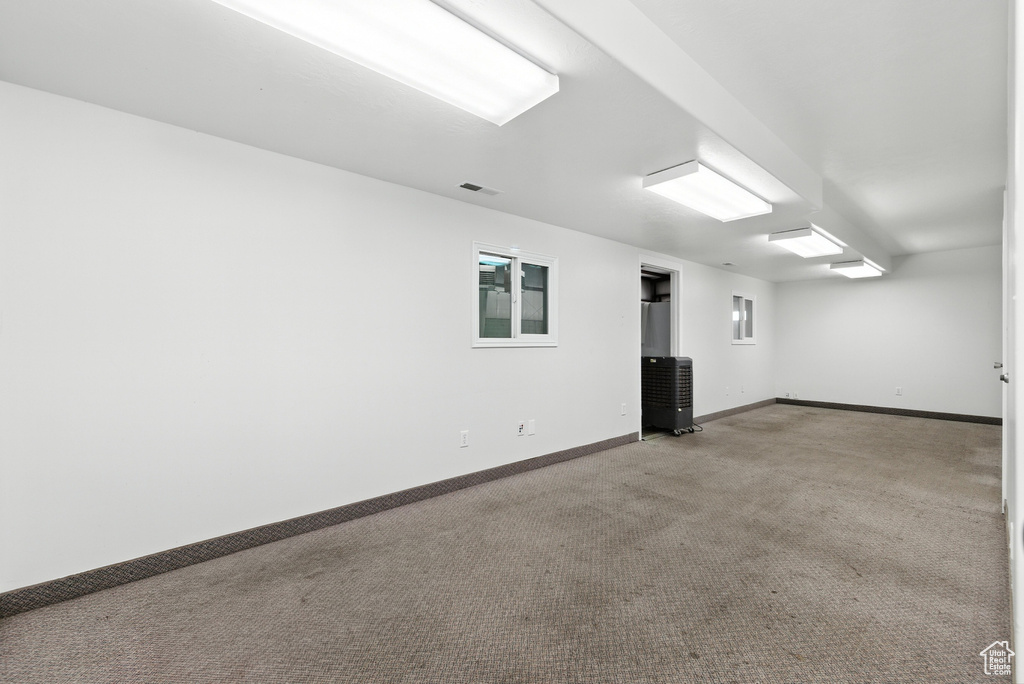 Spare room featuring carpet floors and baseboards