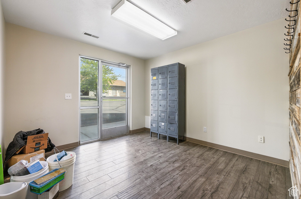 Spare room featuring wood finished floors and baseboards