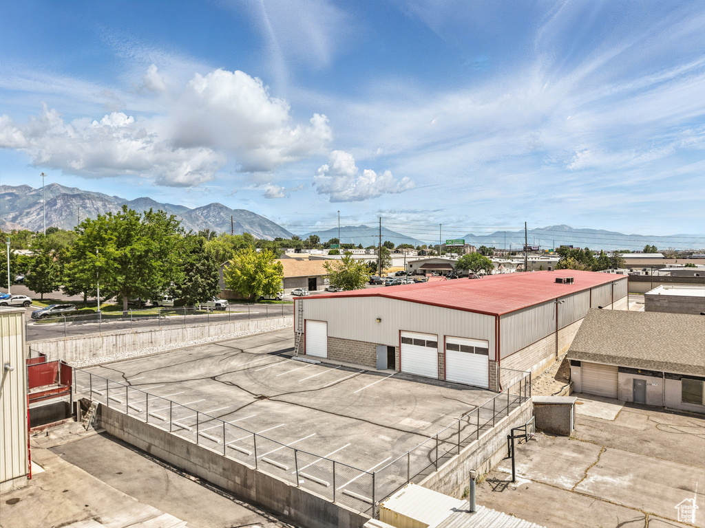 Exterior space featuring a garage, an outbuilding, and a mountain view