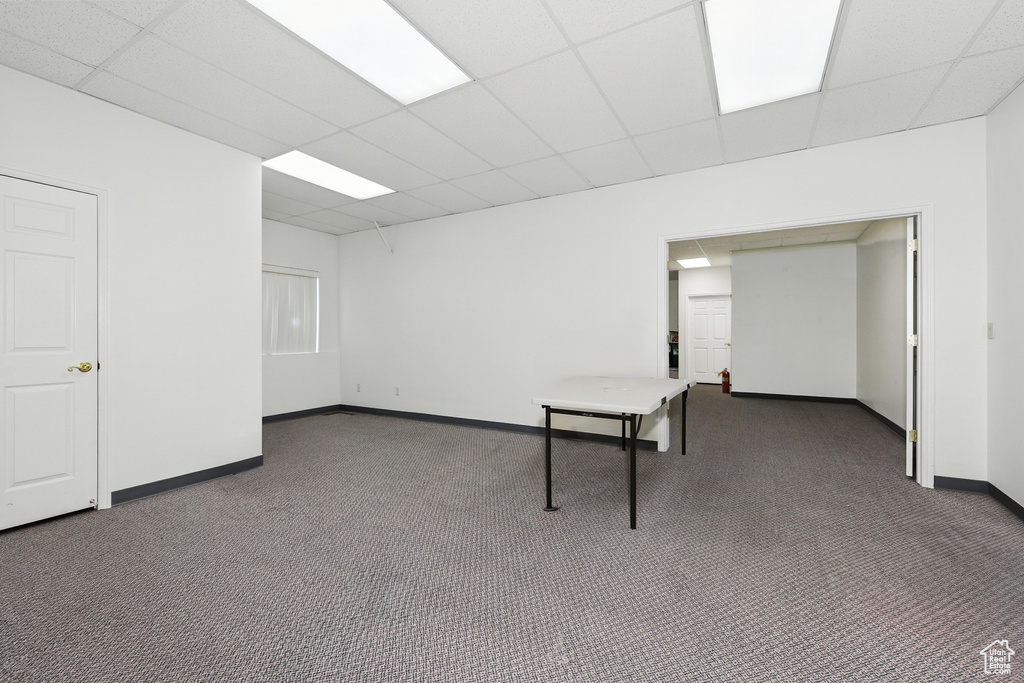 Carpeted spare room with a paneled ceiling