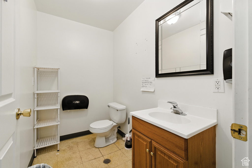 Half bath with vanity and tile patterned floors