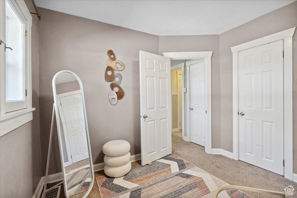 Bedroom featuring carpet and baseboards