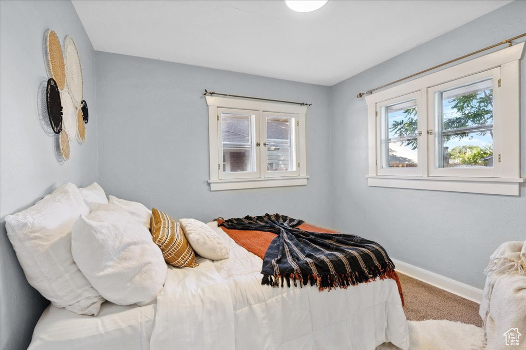 Bedroom featuring carpet floors and baseboards