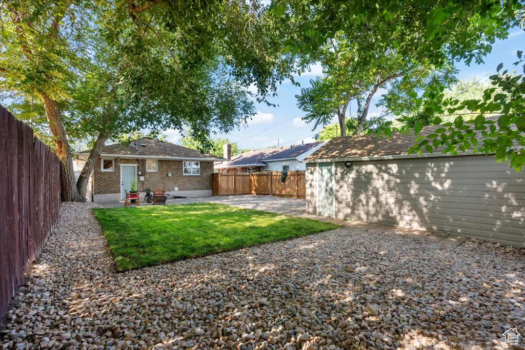 Fenced backyard with a patio area and entry steps