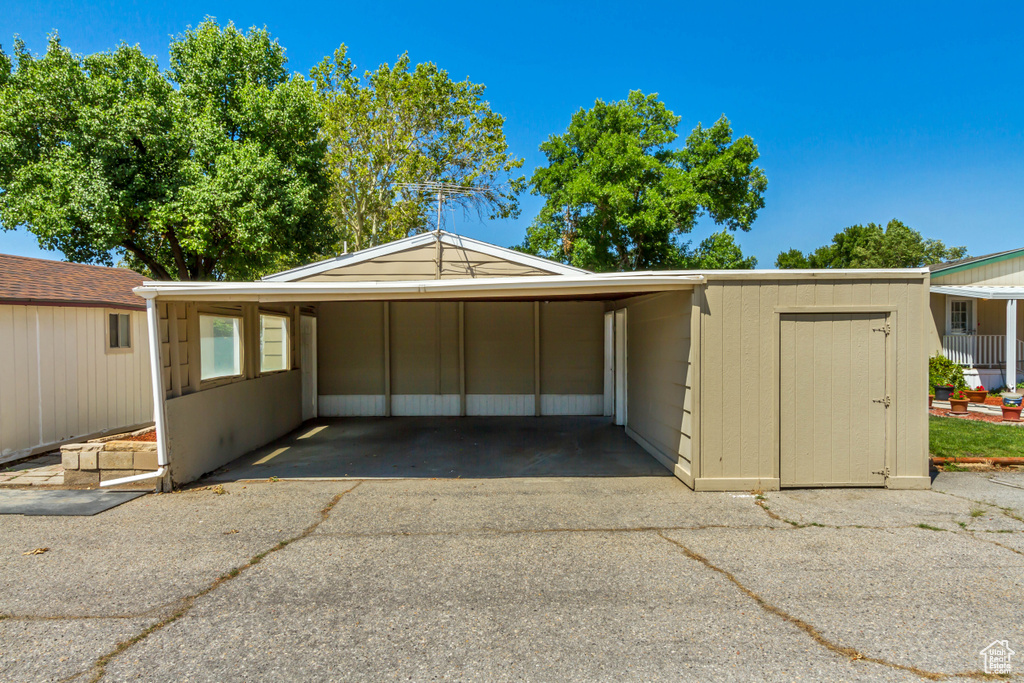 Garage featuring a carport and driveway