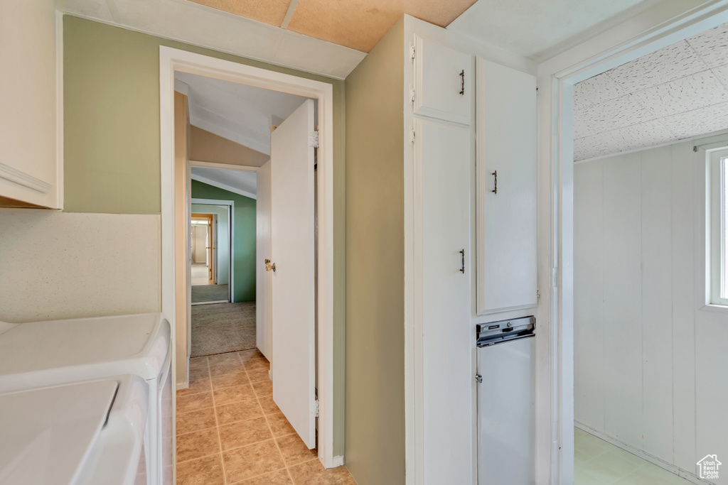 Hall with independent washer and dryer and a paneled ceiling