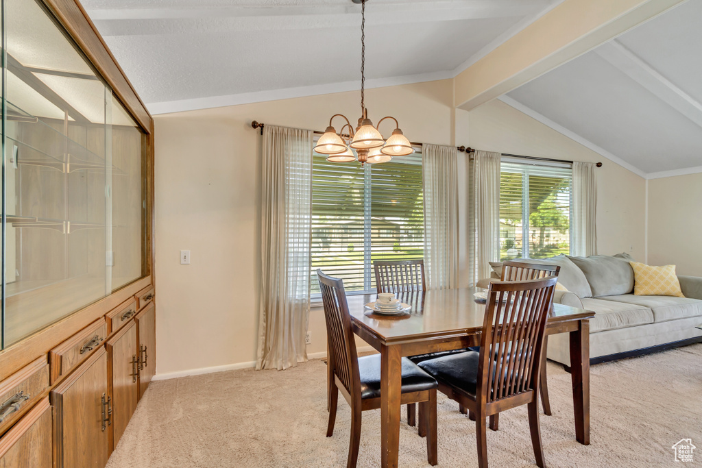 Dining space featuring a chandelier and light colored carpet