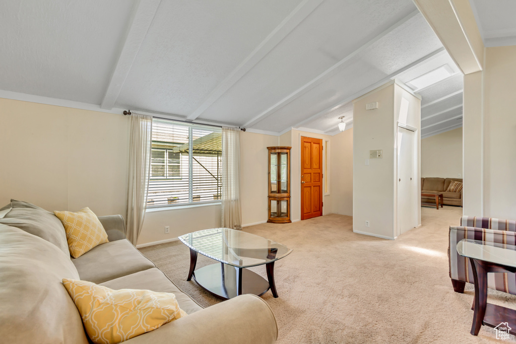 Living area featuring light carpet and baseboards