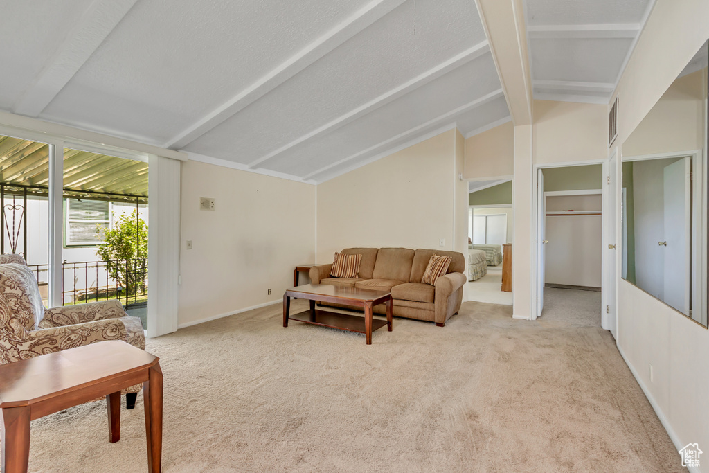 Living area featuring carpet and baseboards