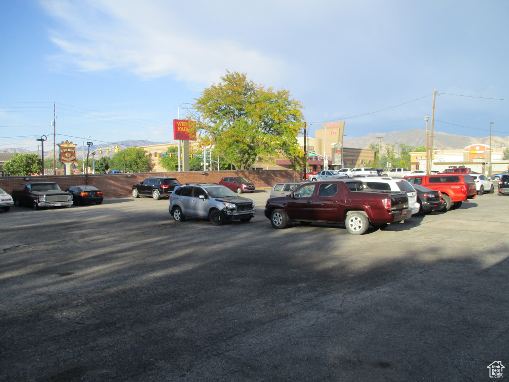 Uncovered parking lot featuring a mountain view