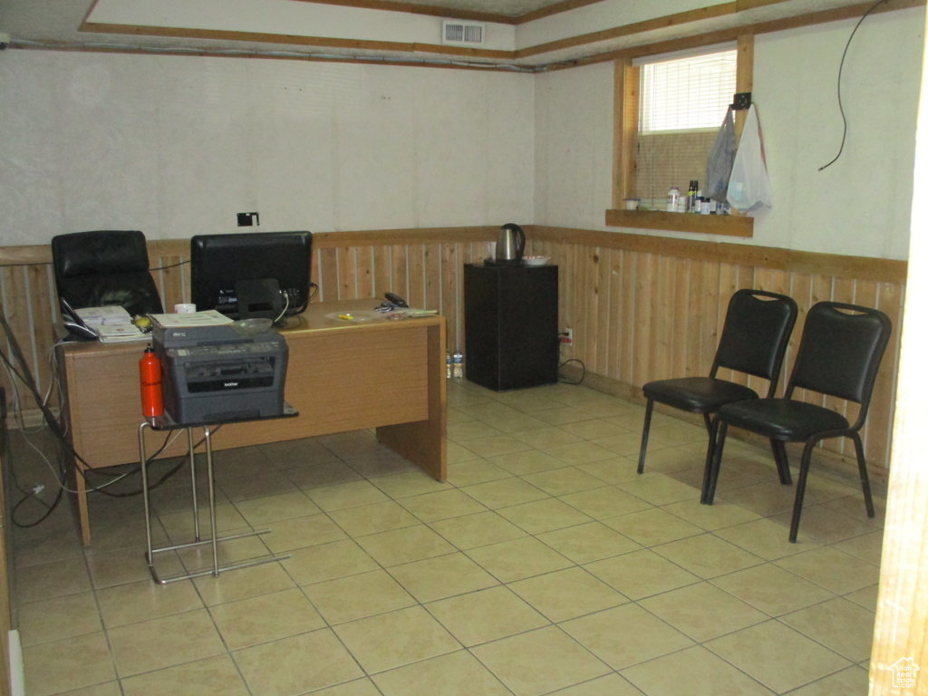 Office area featuring a wainscoted wall and light tile patterned floors