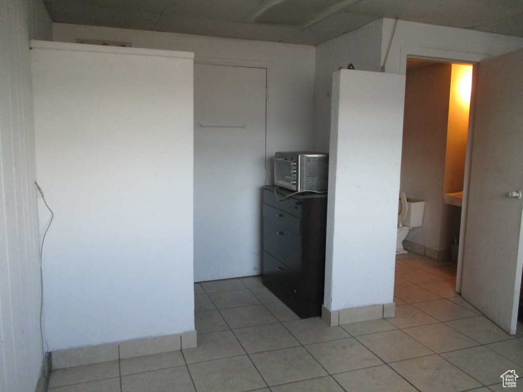 Unfurnished bedroom featuring light tile patterned floors