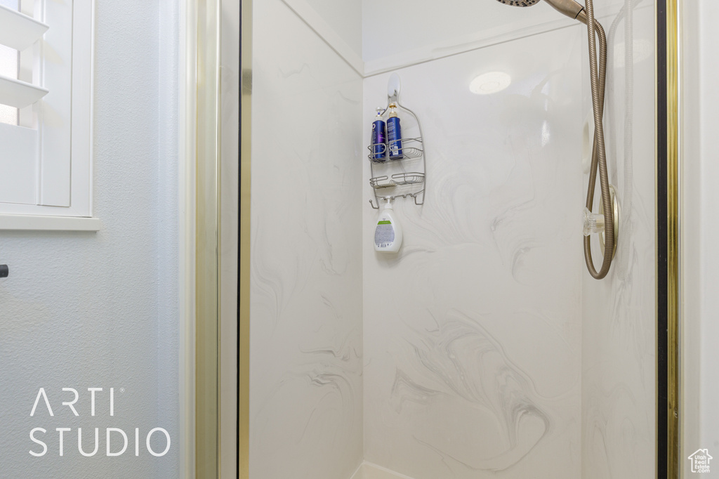 Bathroom featuring a marble finish shower