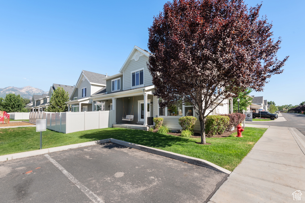 View of front of property with uncovered parking and a residential view