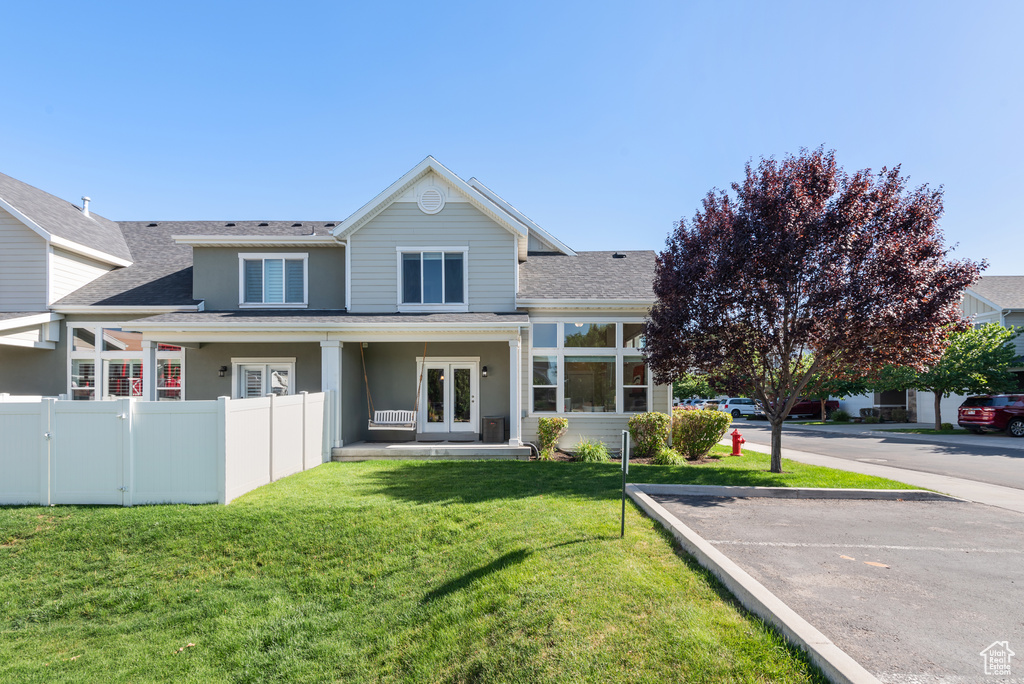 Back of property featuring french doors, roof with shingles, uncovered parking, and stucco siding