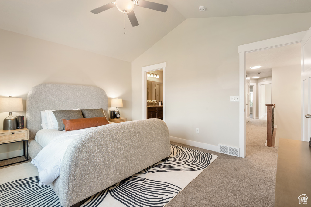 Bedroom featuring carpet, ensuite bath, ceiling fan, and high vaulted ceiling