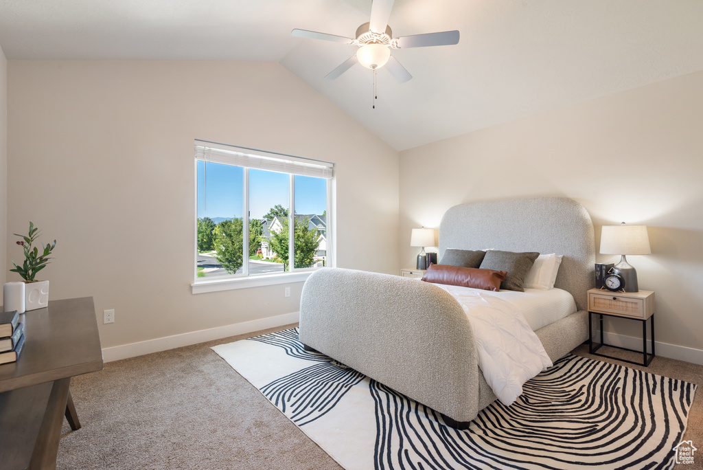 Bedroom with carpet floors, vaulted ceiling, and a ceiling fan