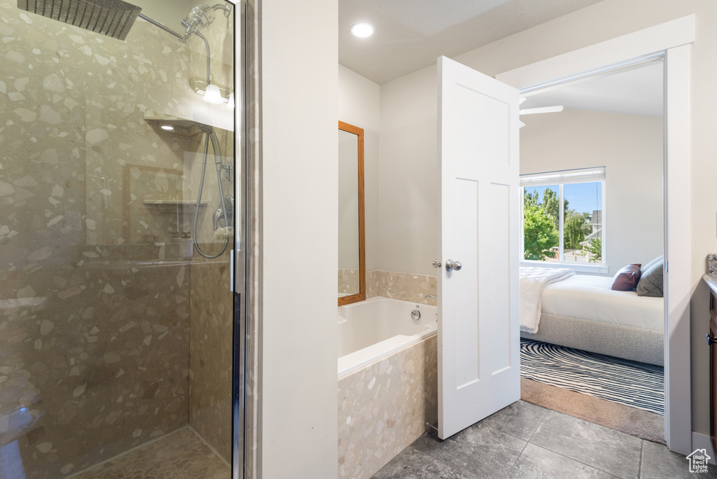 Bathroom with connected bathroom, a bath, tiled shower, tile patterned floors, and vaulted ceiling