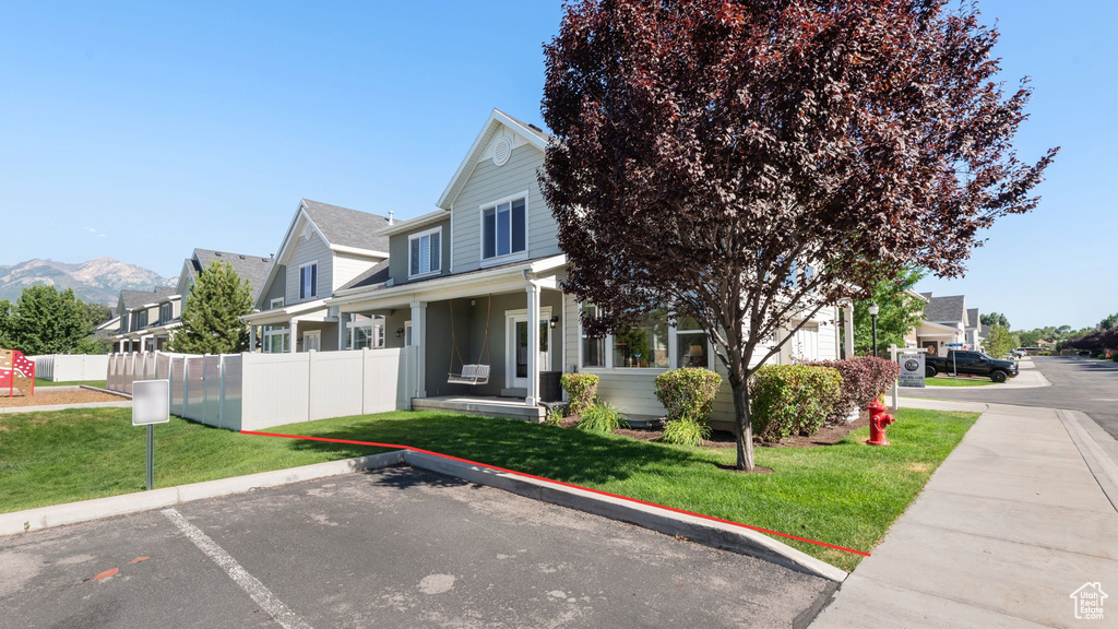 View of front of home with uncovered parking and a residential view