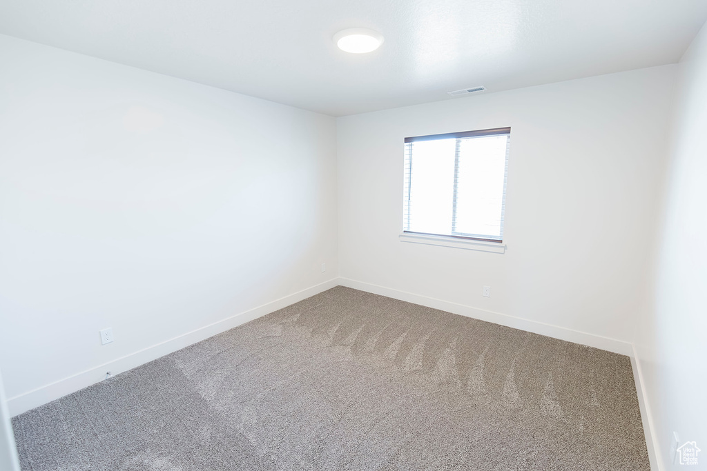 Unfurnished room featuring carpet flooring and baseboards