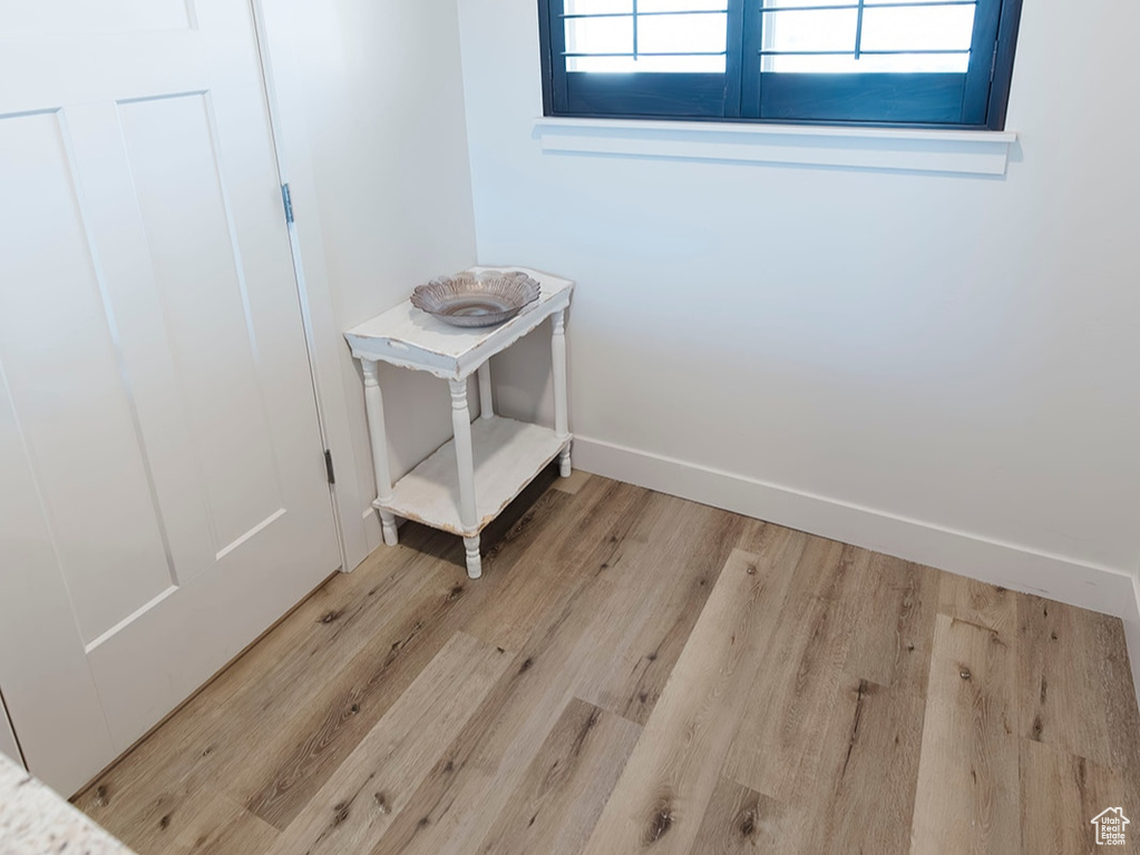 Spare room featuring light wood finished floors and baseboards