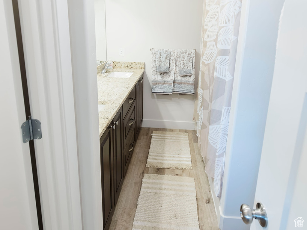 Bathroom featuring wood finished floors and double vanity