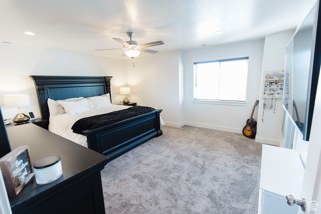 Carpeted bedroom with baseboards and ceiling fan