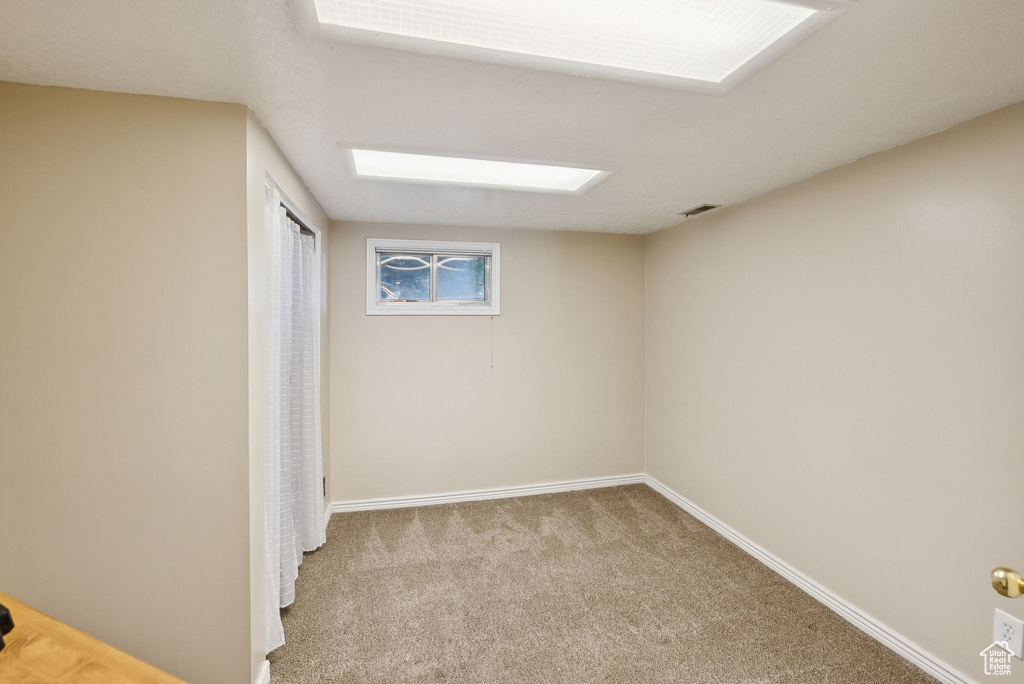 Unfurnished bedroom featuring carpet and baseboards