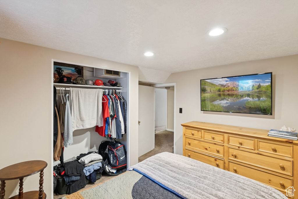 Bedroom with a closet, carpet, and recessed lighting