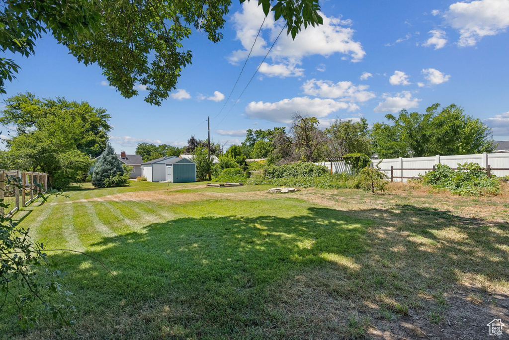 View of yard featuring a storage unit