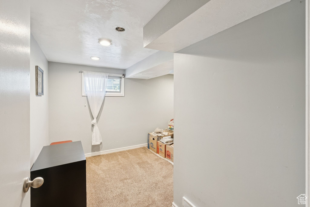 Below grade area featuring carpet floors and baseboards