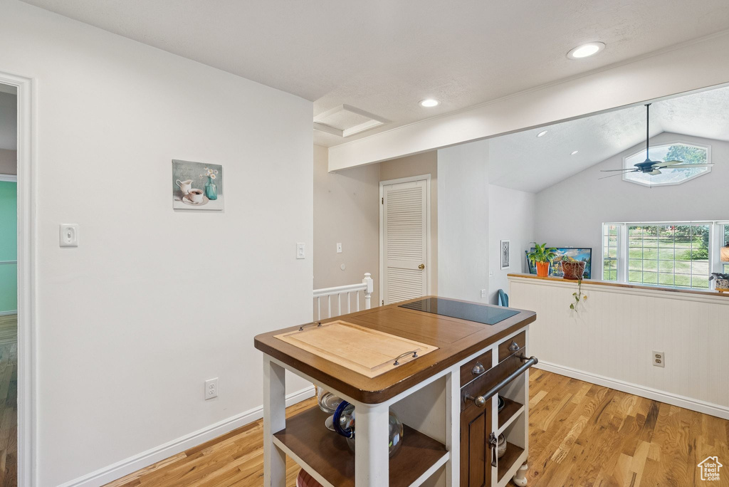 Kitchen with light wood-style floors, vaulted ceiling, a ceiling fan, open shelves, and recessed lighting