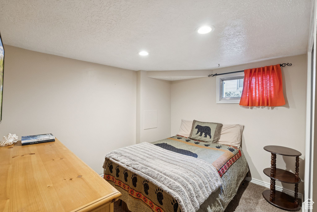 Carpeted bedroom featuring recessed lighting and a textured ceiling