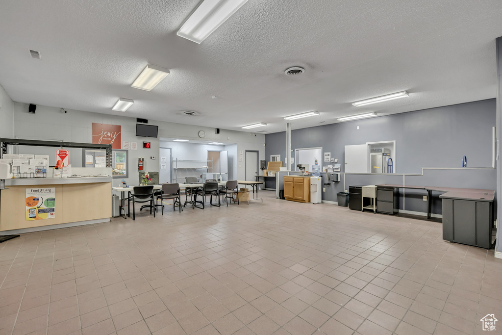 Misc room with a textured ceiling and tile patterned flooring