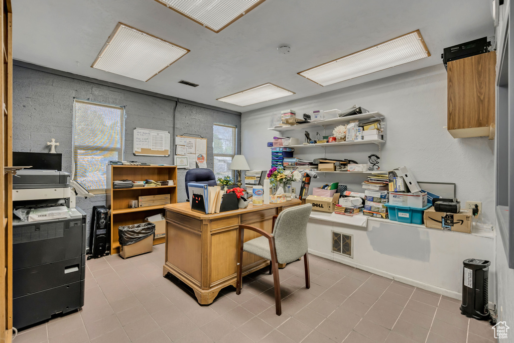 Home office featuring plenty of natural light and light tile patterned floors
