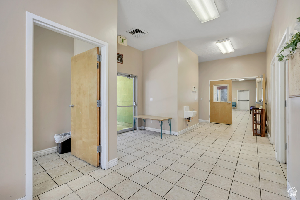 Hallway with light tile patterned floors