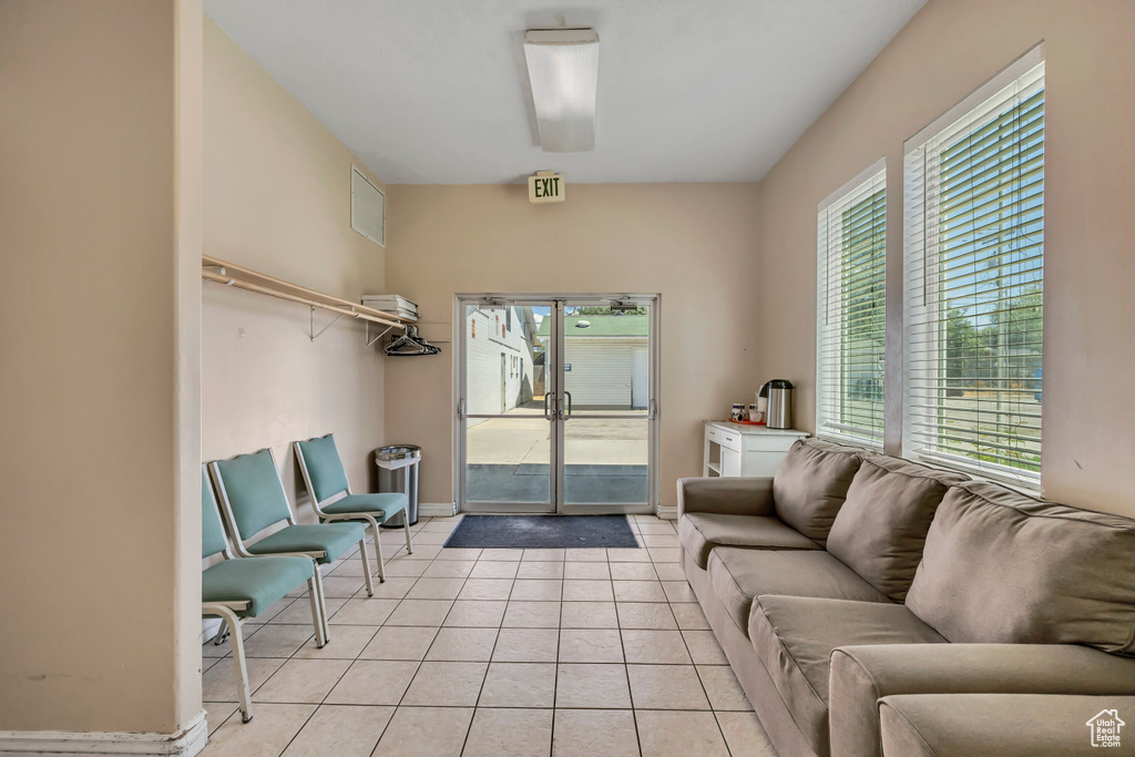 Living room featuring light tile patterned floors and baseboards