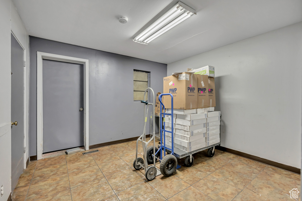 Miscellaneous room featuring baseboards and tile patterned flooring