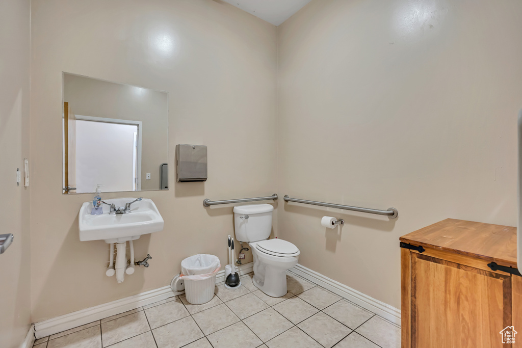 Bathroom with baseboards and tile patterned floors