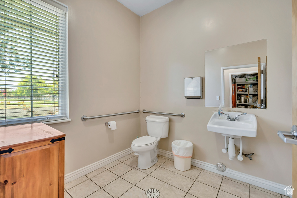 Half bath with tile patterned floors and toilet