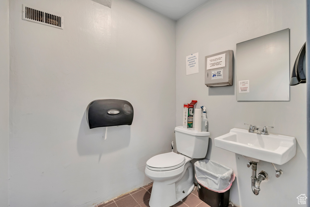 Bathroom with toilet and tile patterned floors