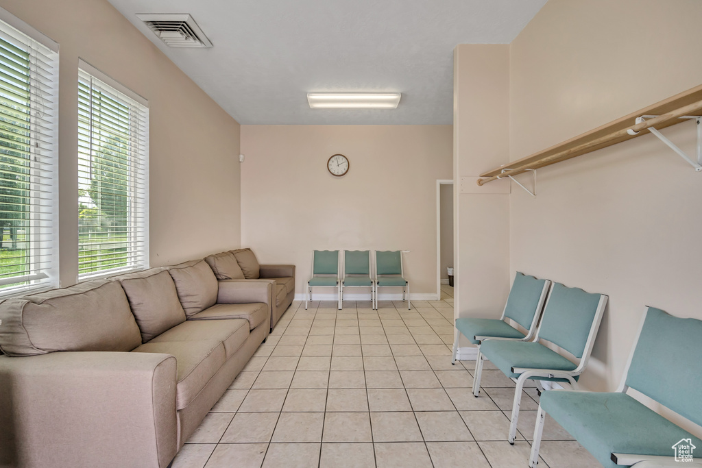 Living area featuring light tile patterned flooring and baseboards