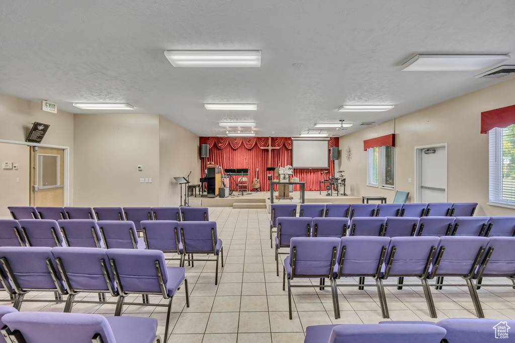Misc room with tile patterned flooring and a textured ceiling