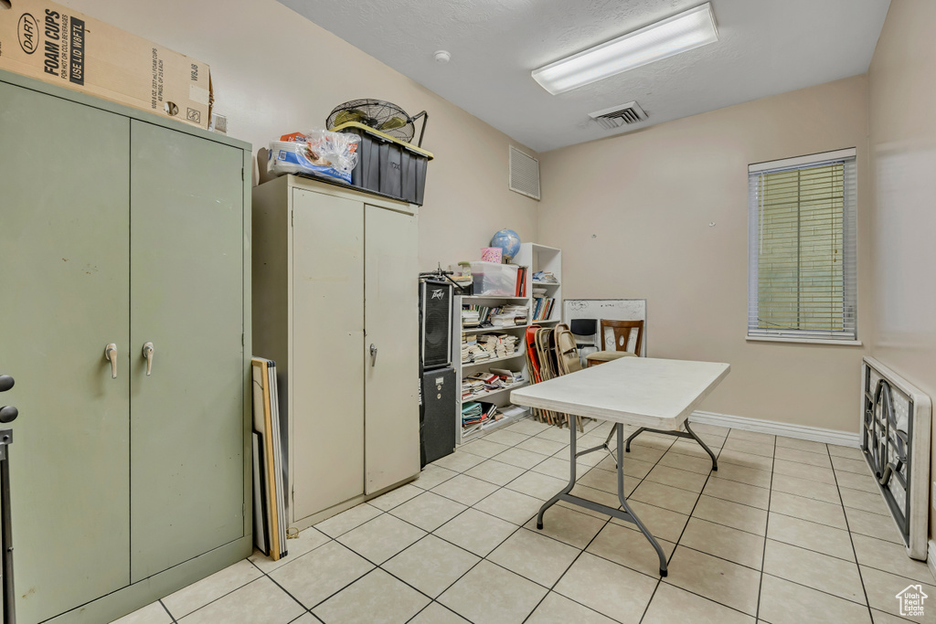 Home office with light tile patterned floors
